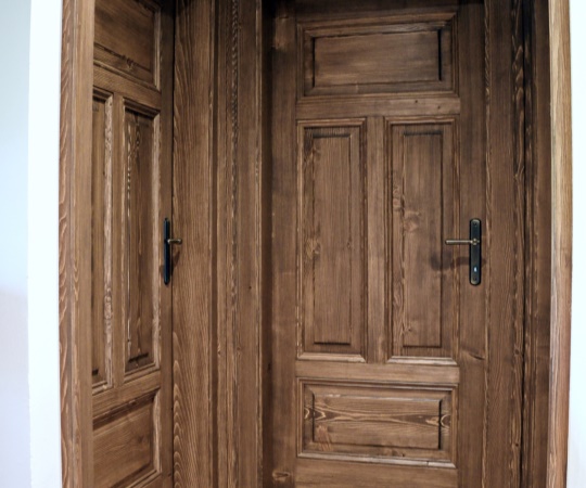 Dveře jednokřídlé, kazetové, včetně obložkové zárubně, smrkový masiv, drásané, nátěr lazurou. Klika Dáša
